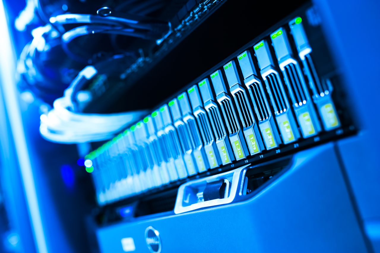 about-img A detailed view of a blue lit computer server rack in a data center showcasing technology and hardware.