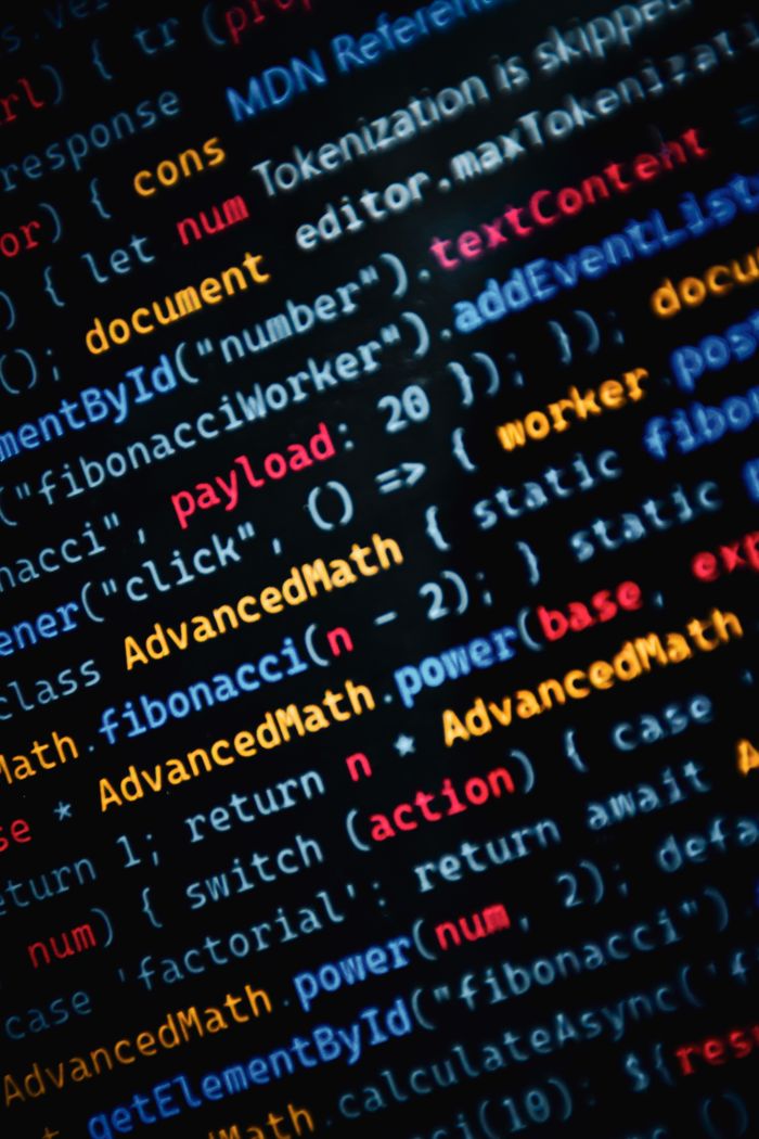 services-04 Close-up of vibrant JavaScript code displayed on a monitor showcasing web development.