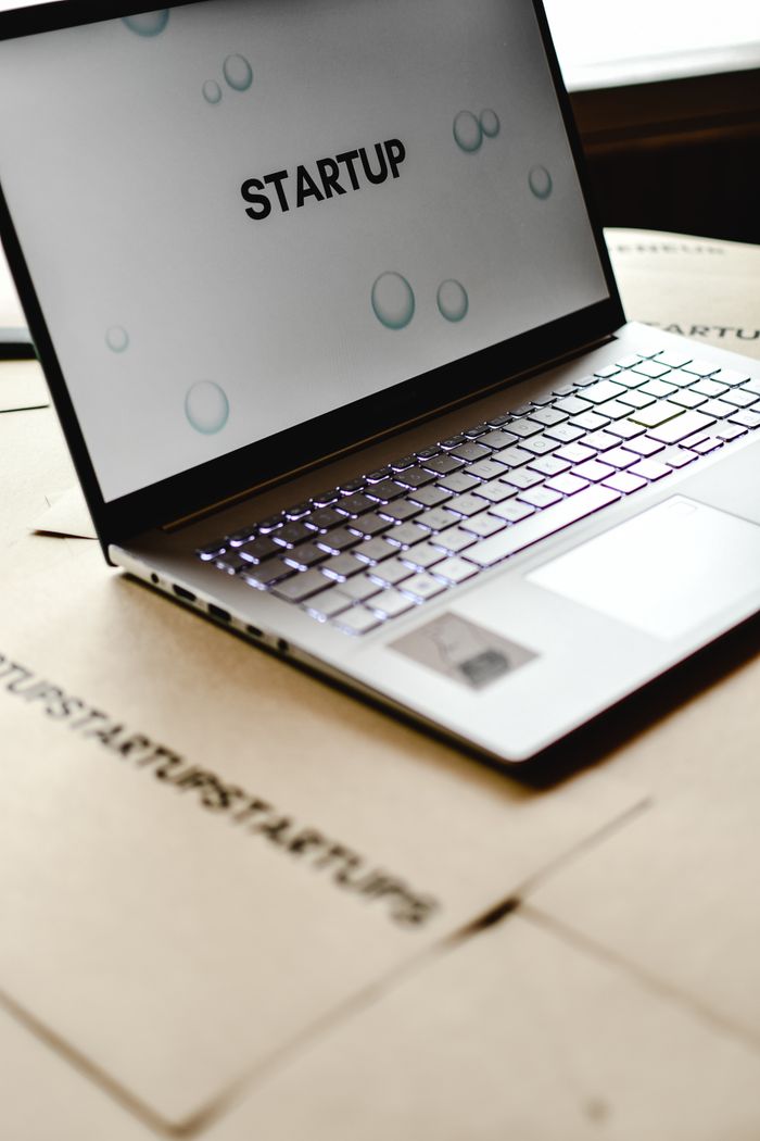 services-img Close-up of a laptop with 'startup' screen on cardboard desk, symbolizing innovative workspaces.
