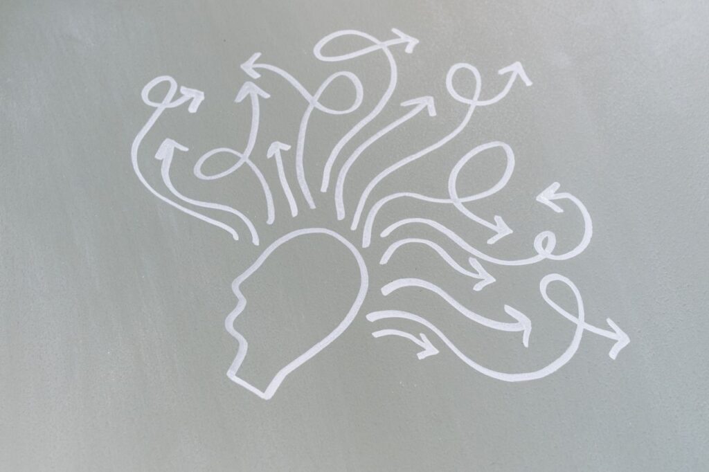 pexels photo 8378726 8378726 Chalk drawing of a head with swirling arrows represents mental activity and thought process.
